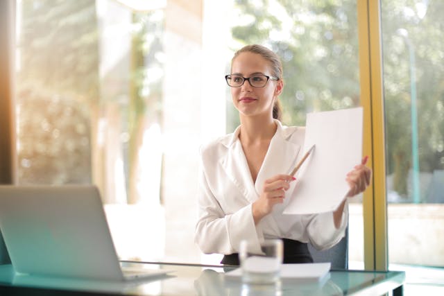 Business person holding up an inspection report explaining something